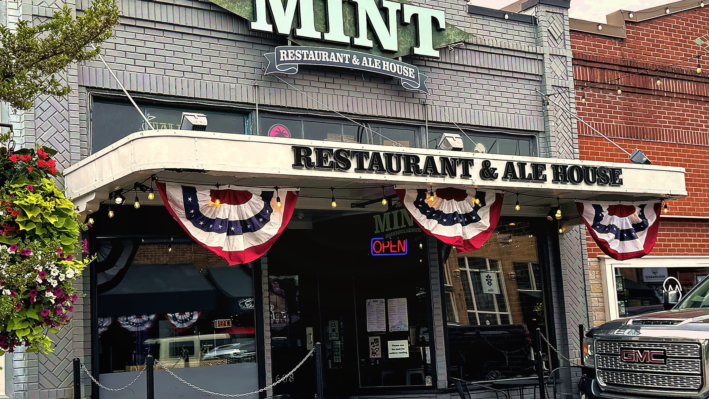 The Historic Mint Restaurant and Alehouse storefront on Cole Street in Enumclaw with bunting over the entrance